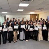 Innovative law firm team celebrating legal achievements at Soliman, Hashish & Partners, showcasing diverse legal professionals and modern office environment in a professional legal services setting.