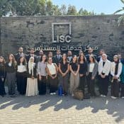 Group of diverse professionals standing in front of the LISC center, highlighting legal and consulting services, with a focus on legal firms and investment consulting.